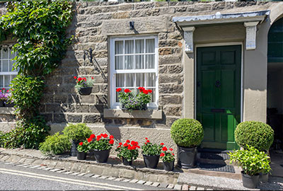 picture of a cottage front door with porch.