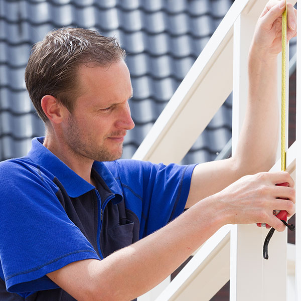 picture of a window fitter installing a window frame.